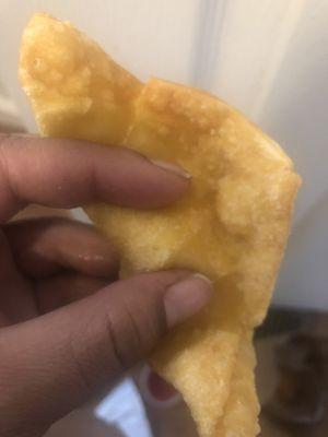 Nickle  size drop of filling between my fingers  and a whole lot of breading