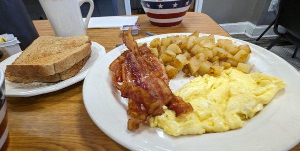 Two eggs with bacon, comes with home fries and toast.