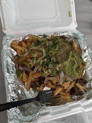 This my Carne Asada Fries. This only french fries, steak is minced cut for the plate w/onions, peppers, guacamole & lettuce