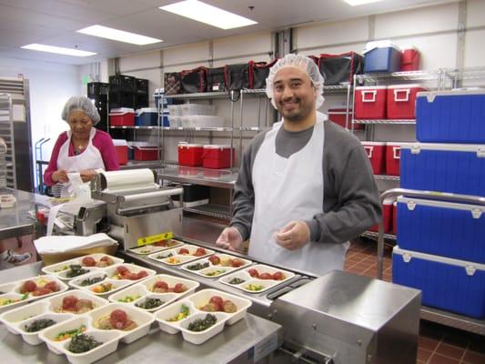 Helping package meals for delivery.