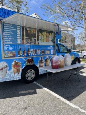 Colorful food truck with their aguas frescas ready to go