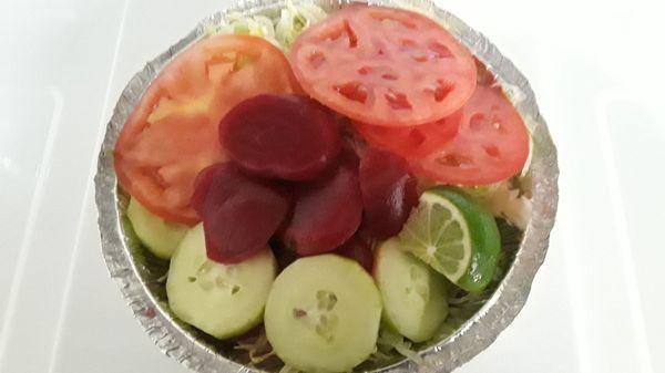 Ensalada / Salad: Shredded iceberg lettuce, cucumber, tomato, beet, served with lime wedge