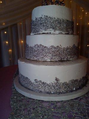 The wedding cake that wasn't level or frosted nicely.  The cardboard is showing between the tiers.