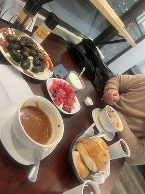 Dolma with yogurt sauce, borscht with beef, pickled cabbage, fresh tea, and homemade bread