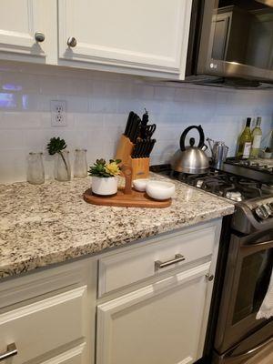 Subway tile, granite countertops, and appliances from Home Depot (LG black stainless steel).