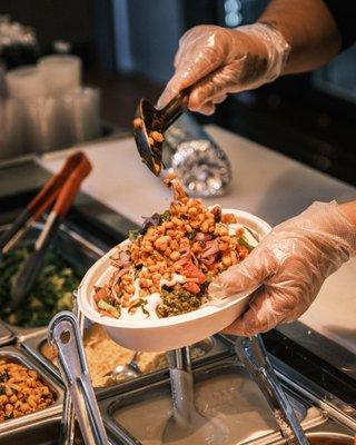 Adding corn in our curry bowl!