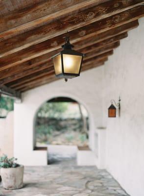 Vaulted wood beam verandas and archways on 3 sides of the Adobe