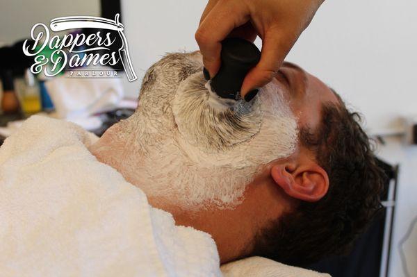 Experience the exceptional closeness and precision of the traditional hot towel shave at Dappers & Dames Parlour.