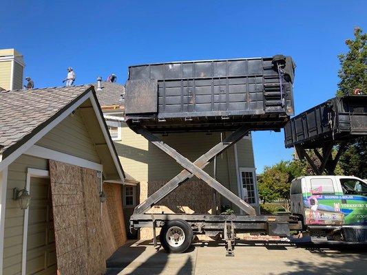 First day stripping old roof. They even put plywood over the garage doors and side of house to stop damage from old shingles coming down