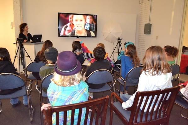 Students watch other actors work.