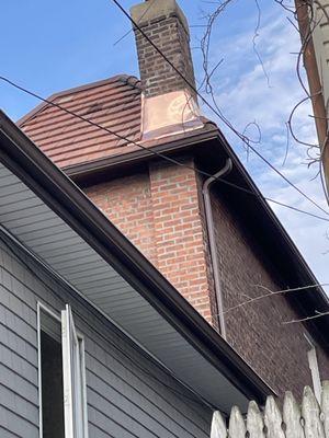 Custom fabricated copper flashing around the chimney.