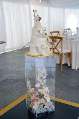 The crown jewel - our adorned wedding cake atop an acrylic box filled with flowers!