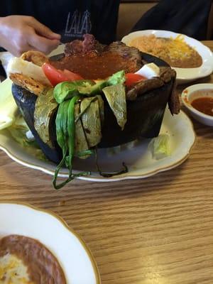 MolcajeteDiana's. It has a beefchicken filet chorizocactus green onion tomato fresh cheese&avocado red salsa complimented rice&b