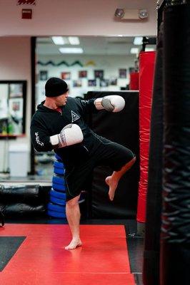 Mikido Black Belt instructor Rob O'Heran and Manager kicking the bags