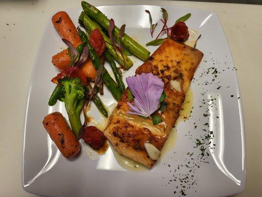 Roasted Salmon
9oz Pan Roasted Salmon with our signature herb butter paste & garlic sauce. Served over sautéed Veggies