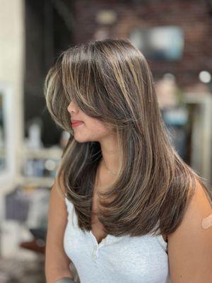 Medium hair layer with curtain bangs by Sharon