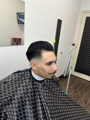 Mid fade comb over slick back.