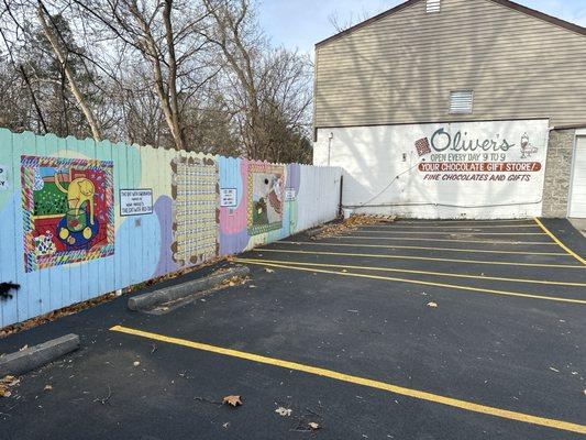 Side of building with artistic fencing in parking lot!