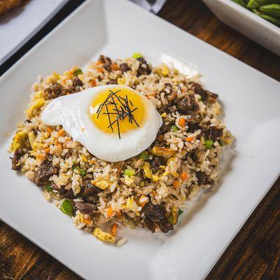 Bulgogi Fried Rice. Korean style fried rice with scrambled egg, vegetables, and sunny side up egg on top.