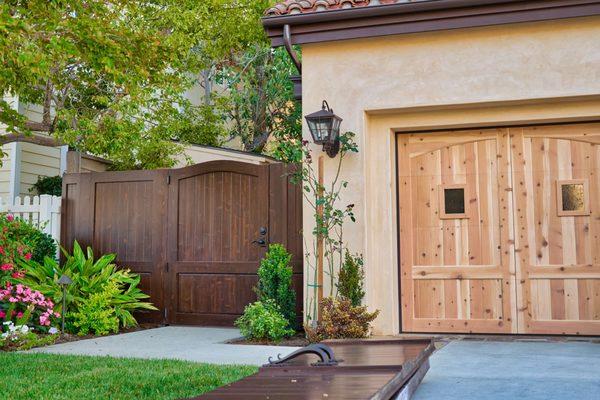 Unfinished Mediterranean Garage Doors and Stained Entry Gate