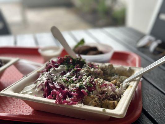 Rice base, chicken shawarma, toppings of ripe red tomatoes and onions, pickled house cabbage, house sauce and parsley with feta.