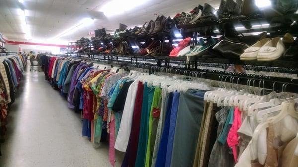 Neat racks of clothes and shoes.