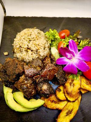 Jerk Pork with rice and peas, plantains and salad