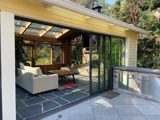 Wood sunroom with retractable glass walls.