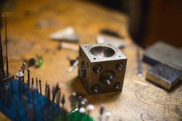 Just a few of the many tools we use to make and repair jewelry. This particular piece is called a "Dapping Block".