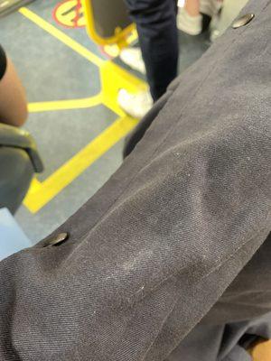 Bottom of shirt, different light, on muni bus