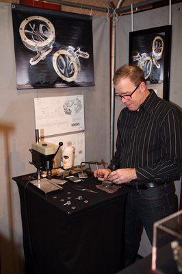 Artist Doug Wunder 'tinkering' in his booth