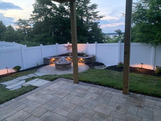 Finished product with the patio pavers, natural rock steps, fire pit and bench.