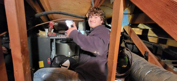 Colton on the heat pump installation.  He is a hard worker