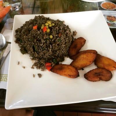 Arroz con calamares. Delicious squid on rice sautéed in onions, peppers and its ink.