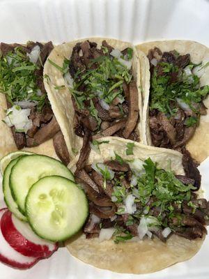 Tacos de Lengua with cucumber and radish slices