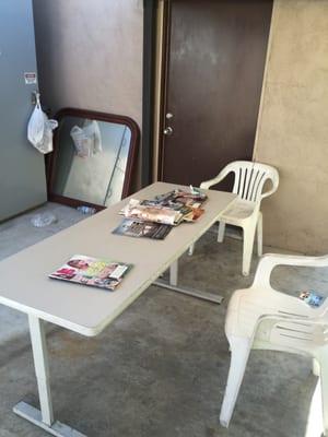 A table and some chairs, under a canopy, while you get your car snigger.