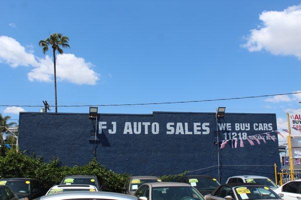 FJ Auto Sales backdrop in sunny Southern California.