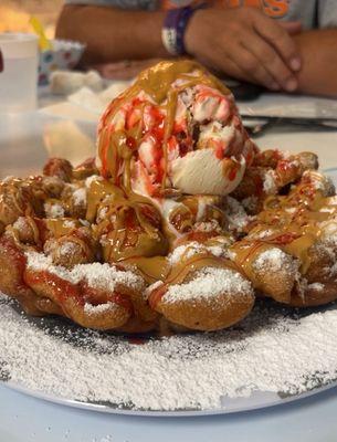 Peanut butter jelly with peanut butter sauce on a funnel cake