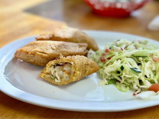 Cross section detail of chicken & vegetable filled little pocket pies made from corn meal