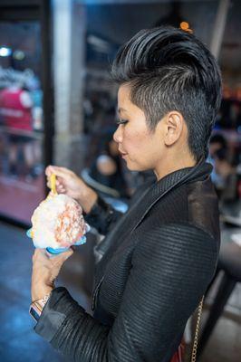 A customer about to dig into an Passion Orange Guava, or POG, shave ice combo with condensed milk available at Sweet Aloha Ice Cream!