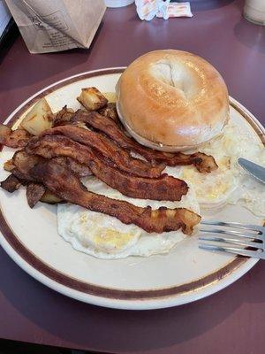 Two eggs, bacon, home fries and bagel