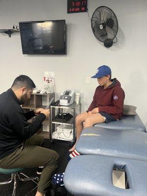 My son being treated by his physical therapist, Mike