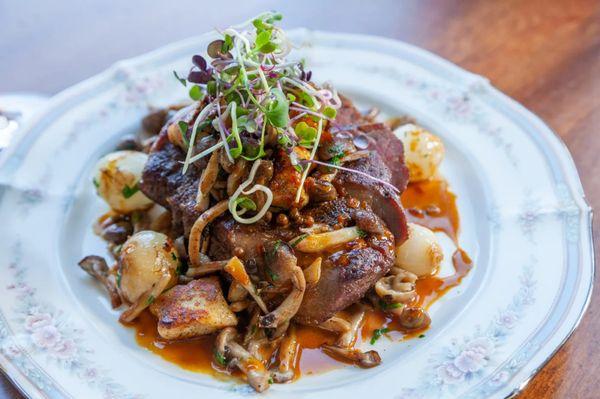 Grilled Australian Grass Fed Ribeye with pearl onions, potato gnocchi, hon shimeji mushrooms & green peppercorn sauce