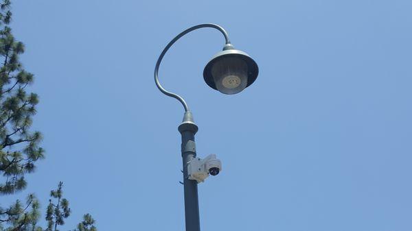 Camera with pole mount adapter on light pole.