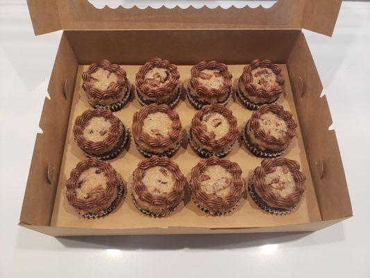 German chocolate cake cupcakes with chocolate frosting inside each one. Beautiful and delicious!