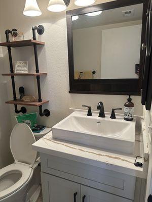 Newly installed bathroom vanity and new countertops and sink