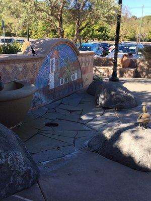 Water fountain with beautiful tile artwork and sculptures by local artists.