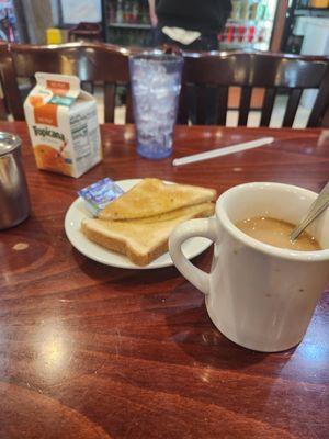 Coffee, orange juice, and toast with butter.