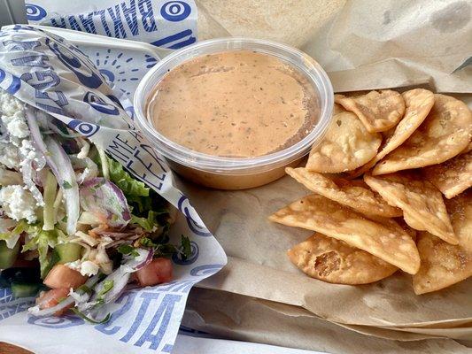 Chicken gyro with hummus and chips.