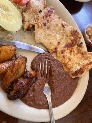 Chicken breast with refried beans, sweet plantains and a side salad